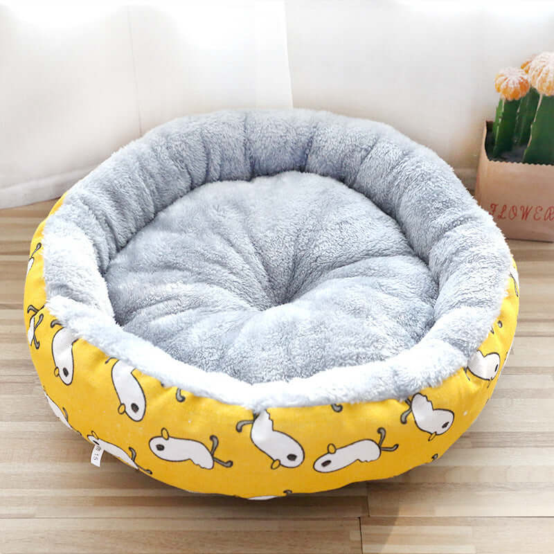 Dog And Cat Litter Padded With Round Cotton in yellow with cartoon pattern and soft gray interior.