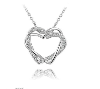 Double diamond heart necklace earring set showcasing an intricate heart design embellished with crystals.